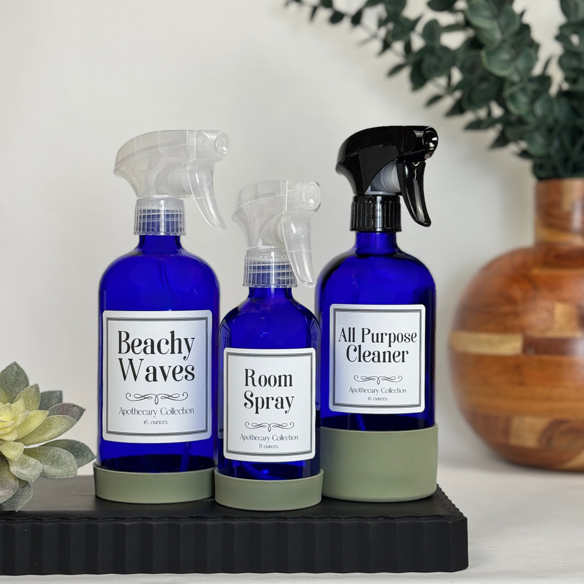 Cobalt blue glass dispenser with silicone sleeve showing spray top options with Apothecary label