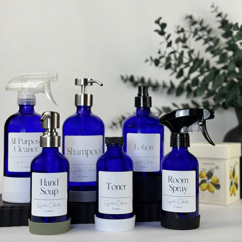 Cobalt blue glass dispenser with silicone sleeve shown with multiple pump and spray top styles