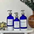 Cobalt blue glass dispensers with white silicone sleeves, Signature labels and black pumps